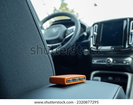 Car ignition key on the armrest in the interior of a modern car. Forgot my keys in the car. Royalty-Free Stock Photo #2320877295