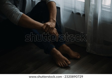 Alone man silhouette staring at the window closed with curtains in bedroom. Man stands at window alone Royalty-Free Stock Photo #2320890729