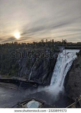 Bathed in the warm embrace of the setting sun, Montmorency Falls reveals its majestic beauty. The golden hour casts a magical glow, enhancing the cascading waters and surrounding nature.