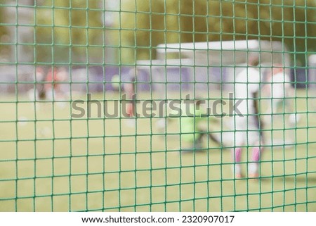 Football, soccer field, soccer gate, view from soccer goal net, blurred stadium, field pitch. Soccer school. Football outdoor stadium. Blurred image for Background