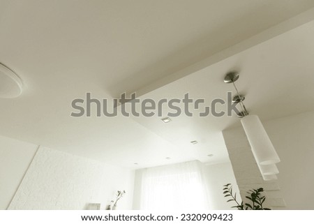 Clean gypsum board ceiling in construction site. Under construction a new house with interior modern style. Royalty-Free Stock Photo #2320909423