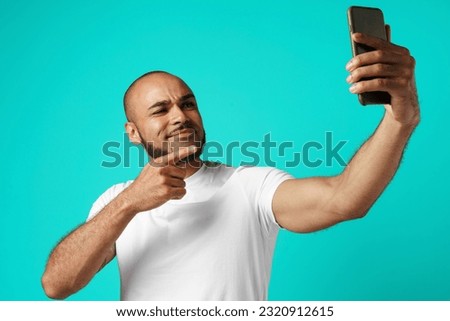 Young cheerful african american man taking selfie picture