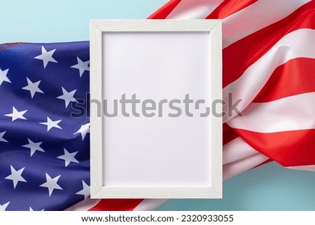 American federal holiday concept. High angle view photo of white rectangular wooden frame the flag of United States of America on blue isolated background with copy-space