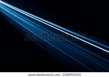 blue car lights at night. long exposure. Royalty-Free Stock Photo #2320933255