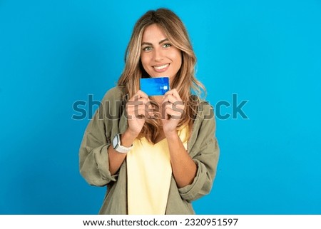 Photo of young beautiful blonde woman wearing overshirt positive smile hold credit card income salary