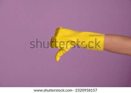 gloved hand making negative sign