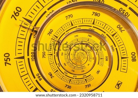 A retro analog barometer spiraling into itself Royalty-Free Stock Photo #2320958711