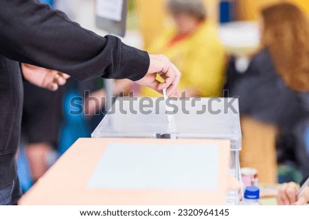 voting candidate campaign in democracy ballot box. Latin mid hand unrecognizable man  Royalty-Free Stock Photo #2320964145