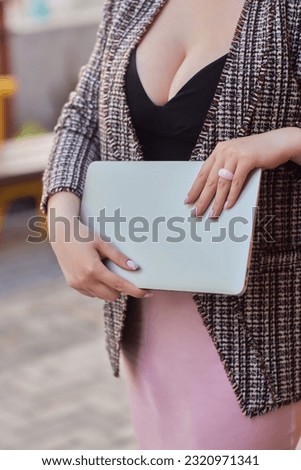 Portrait of beautiful plus size woman 30-35 years old in fashion clothes and eyeglasses working remotely on a laptop on vacation