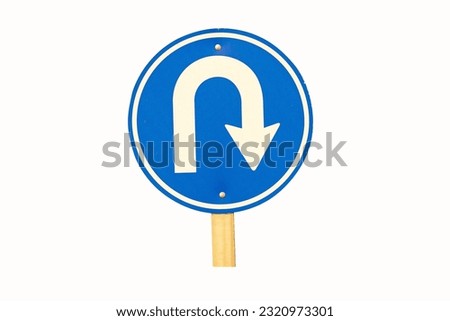 U turn sign blue for motorbike, car side street. Rules for road users. It's traffic sign. Isolated on white background. In nature daylight. Bold white symbol arrow indicating maneuver.