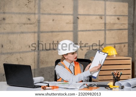 engineer smart young cute blonde girl civil worker in helmet and vest
