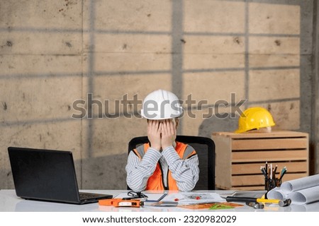engineer smart young cute blonde girl civil worker in helmet and vest covering face