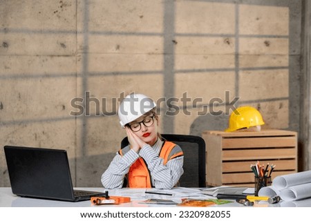 engineer in helmet and vest civil worker smart young cute blonde girl sleeping