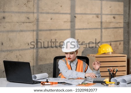 engineer civil worker in helmet and vest smart young cute blonde girl working