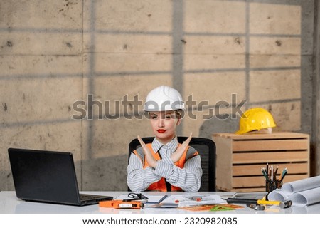 engineer civil worker in helmet and vest smart young cute blonde girl showing stop sign