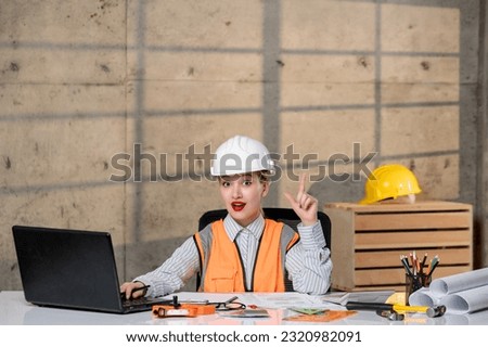 engineer civil worker in helmet and vest smart young cute blonde girl having an idea
