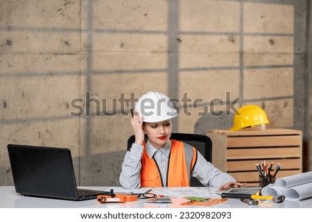 engineer civil worker in helmet and vest smart young cute blonde girl focused