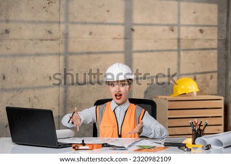 engineer young smart cute blonde girl civil worker in helmet and vest with new project