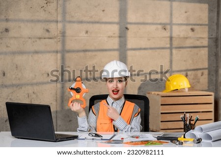 engineer young smart cute blonde girl civil worker in helmet and vest with tools