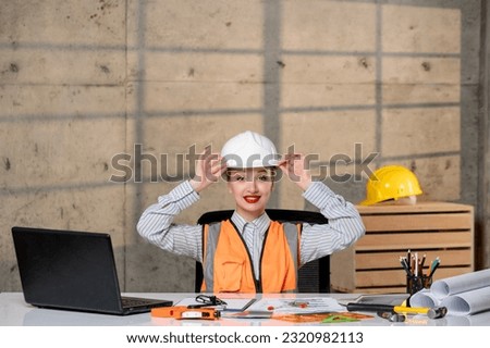 engineer young smart cute blonde girl civil worker in helmet and vest very excited
