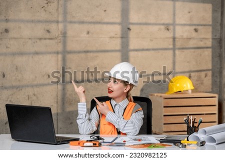 engineer young smart cute blonde girl civil worker in helmet and vest having an idea about plan