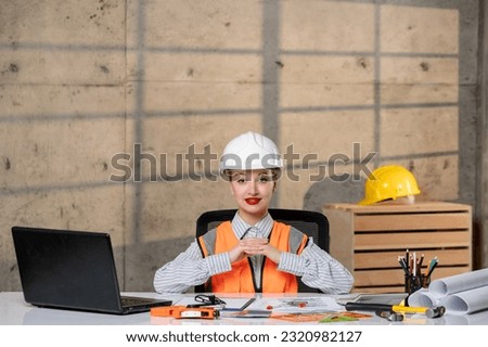 engineer young smart cute blonde girl civil worker in helmet and vest having an idea