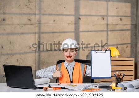engineer young smart cute blonde girl civil worker in helmet and vest happy