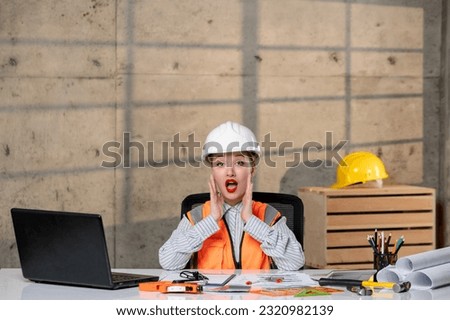 engineer smart young cute blonde girl civil worker in helmet and vest yelling