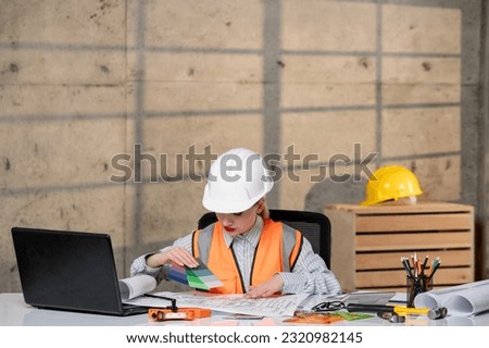 engineer smart young cute blonde girl civil worker in helmet and vest with ruler