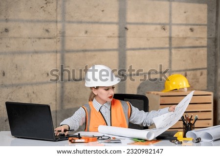 engineer smart young cute blonde girl civil worker in helmet and vest with project
