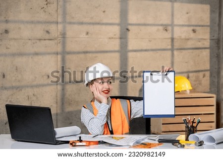 engineer smart young cute blonde girl civil worker in helmet and vest with new plan