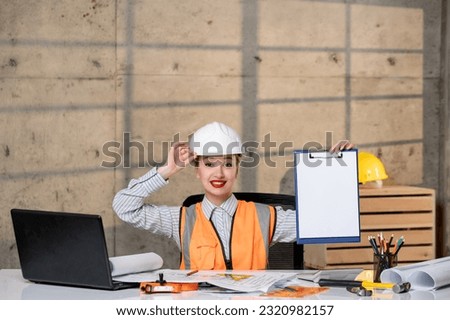 engineer smart young cute blonde girl civil worker in helmet and vest very excited about plan