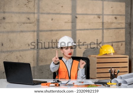 engineer smart young cute blonde girl civil worker in helmet and vest showing stop sign