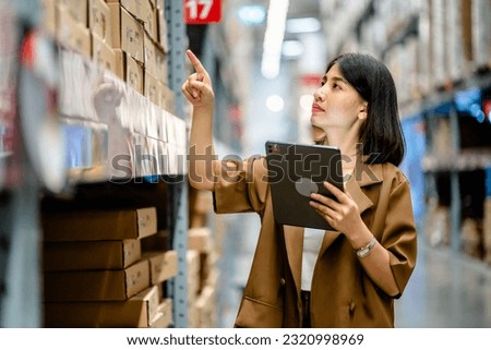 Women warehouse worker using digital tablets to check the stock inventory on shelves in large warehouses, a Smart warehouse management system, supply chain and logistic network technology concept Royalty-Free Stock Photo #2320998969