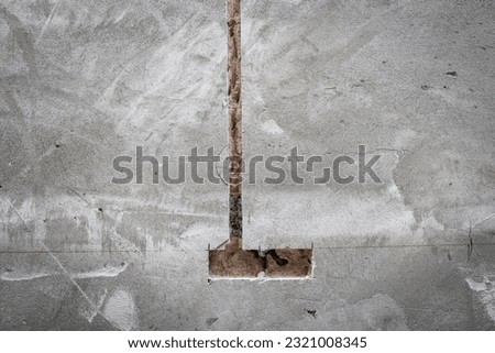 Hole in concrete wall, Unfinished electrical mains outlet socket without electrical wires - concrete wall.