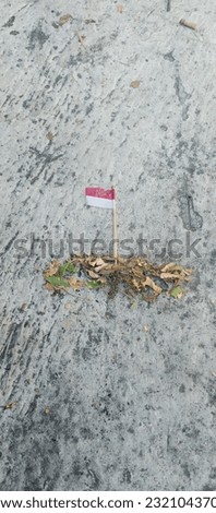 red and white flag of plastic combined with dry leaves