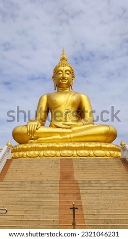 Paying homage to the big Buddha statue outdoors with sky background