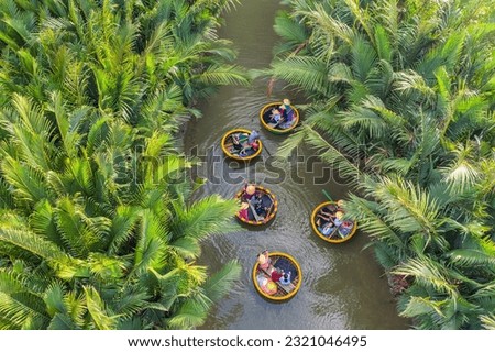 Aerial view, tourists from Thailand, Korea, America and Japan are relax and experiencing a basket boat tour at the coconut water ( mangrove palm ) forest in Cam Thanh village, Hoi An,Quang Nam,Vietnam Royalty-Free Stock Photo #2321046495