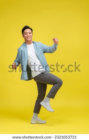Handsome young man on color background Royalty-Free Stock Photo #2321053721
