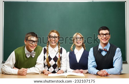 Four nerds in front of blackboard 