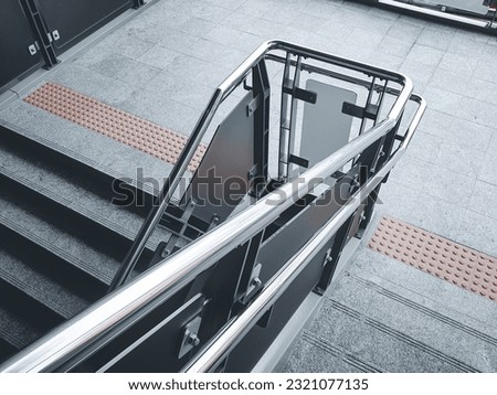 Stainless steel railing at station. Fall Protection.  Royalty-Free Stock Photo #2321077135