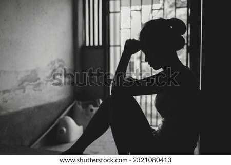 Silhouette of Desperate people are in a dark cell. Human trafficking, Stop abusing violence. Royalty-Free Stock Photo #2321080413
