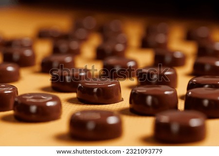 Sweets candy on chocolate factory conveyor. Process cocoa glazing marzipan. Royalty-Free Stock Photo #2321093779