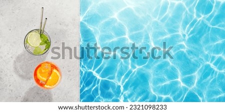 Refreshing cocktails by the pool on a sunny day, the perfect summer vacation. View from above with space for your text Royalty-Free Stock Photo #2321098233