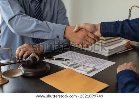 A lawyer or court receives money from a businessman in exchange for help, an unfair judgment is fraud and bribery, the lawyer holds a pen to sign a contract on the table.