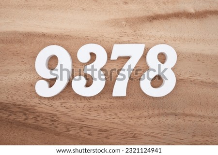 White number 9378 on a brown and light brown wooden background.