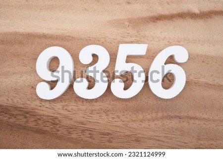 White number 9356 on a brown and light brown wooden background.
