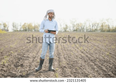 Young Indian farmer in his field.