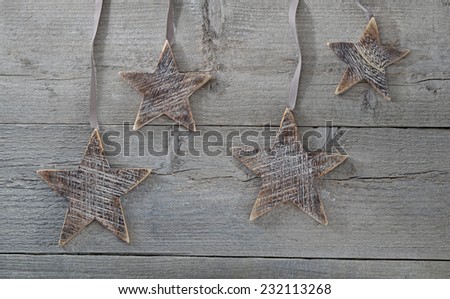 wooden rustic stars decorations on stressed wood