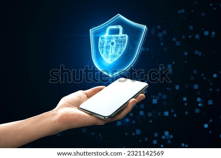 Internet security, cyber access protection and online safety concept with glowing padlock in shield symbol above human hand with modern smartphone on abstract dark pixel background
